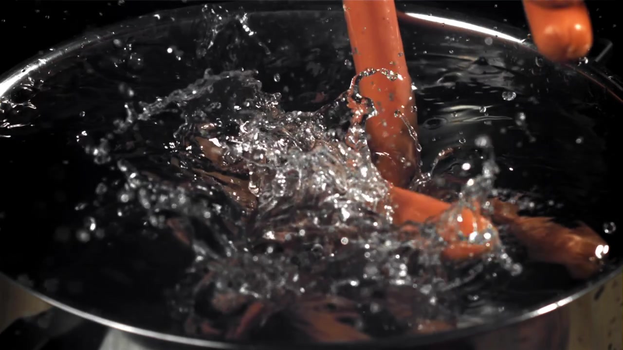 Sausages Dropping into Water and Boiling in Slow Motion