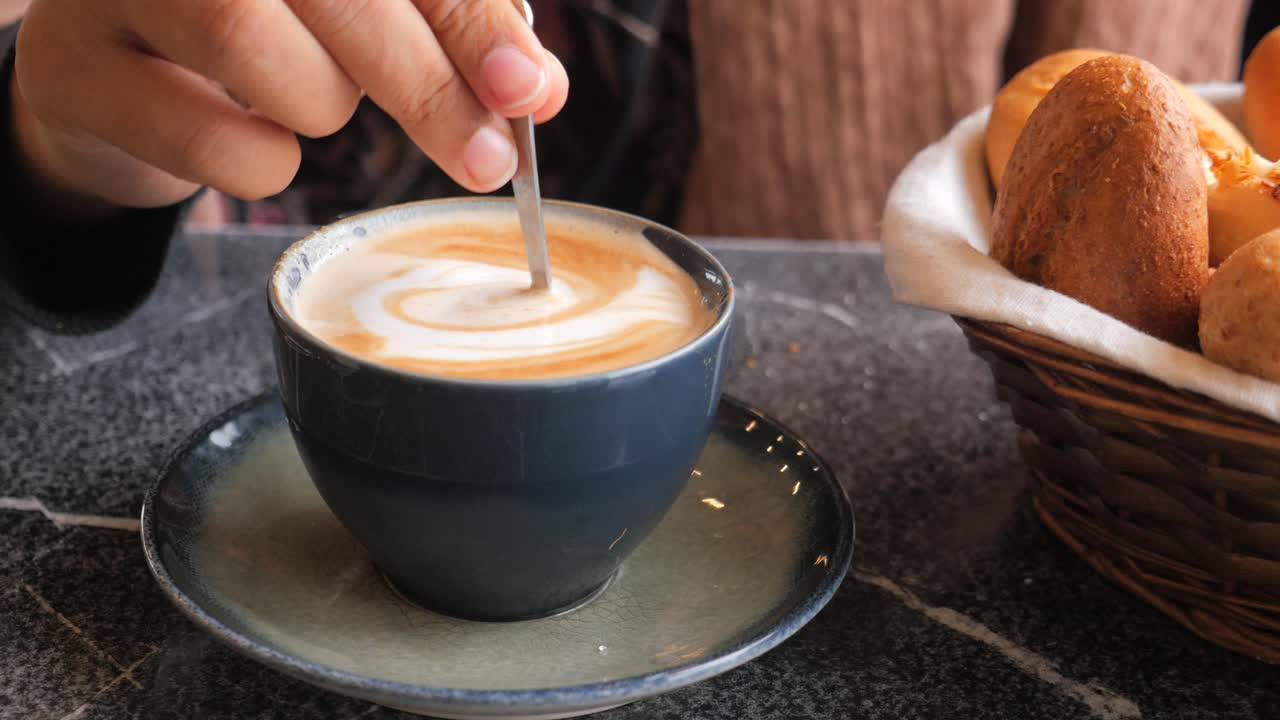 Person enjoying coffee and pastries