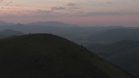people admire panorama at sunset from summit of mountain, iraty viewpoint, biarritz in france