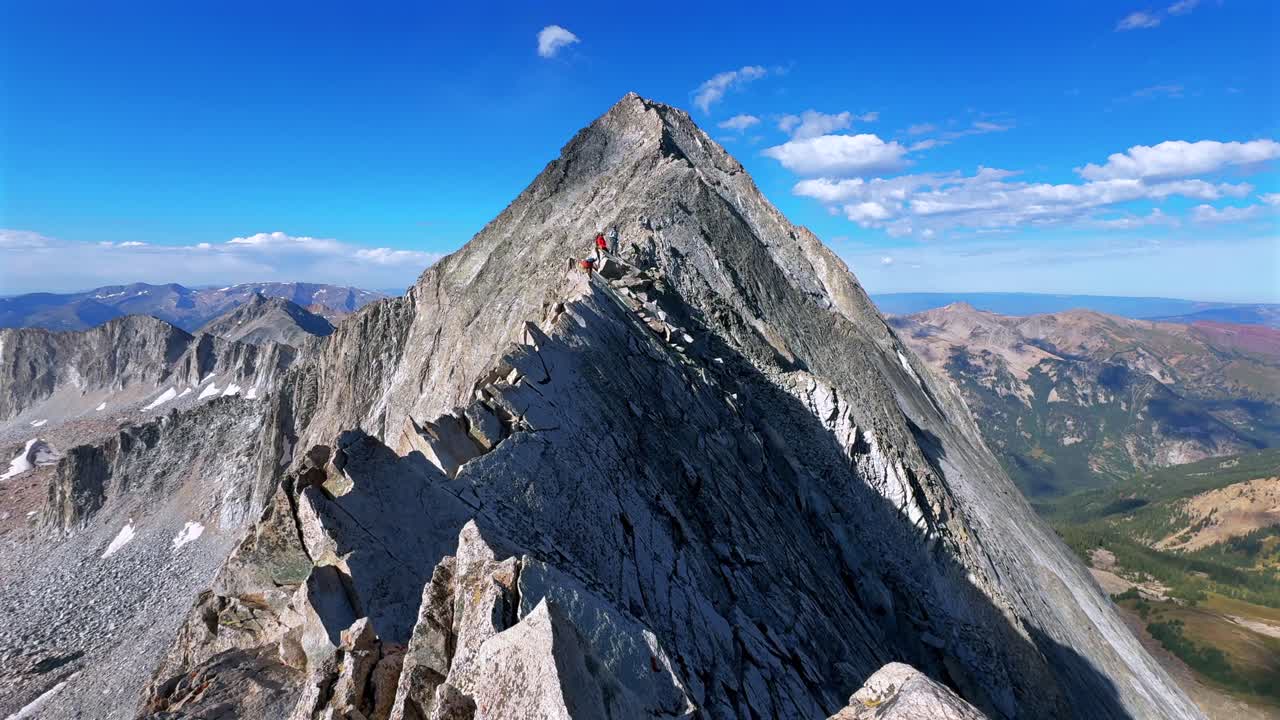 Hiking Capitol Peak Wilderness Knifes Edge North East Ridge Trail scrambling rock climbing Rocky Mountains Colorado 14er boulders summer blue sky morning sunny rugged terrain static shot