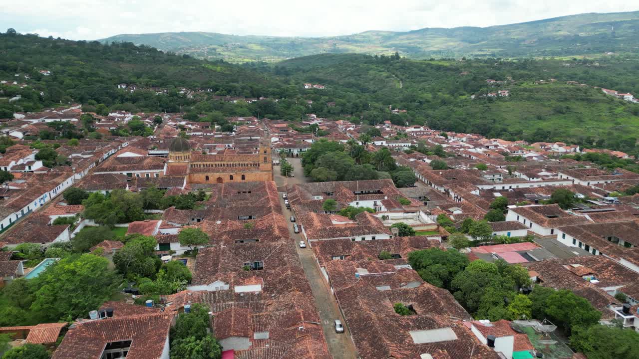Aerial views of the Andean village of Barichara in the Santander Department of Colombia, featuring colonial clay houses, red-tiled roofs, cobblestone streets and La Inmaculada Concepción church