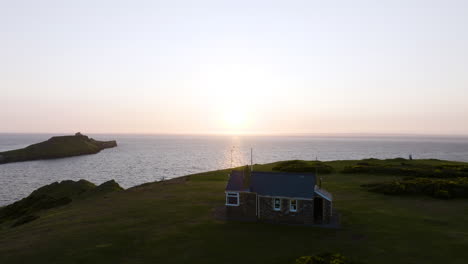 coastal sunset view with small house