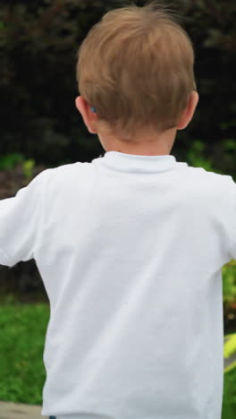 un niño gira su scooter enérgicamente en sentido antihorario en un camino entrelazado en un parque