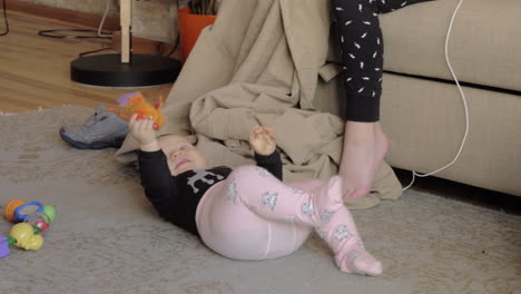 adorable baby girl playing on the carpet