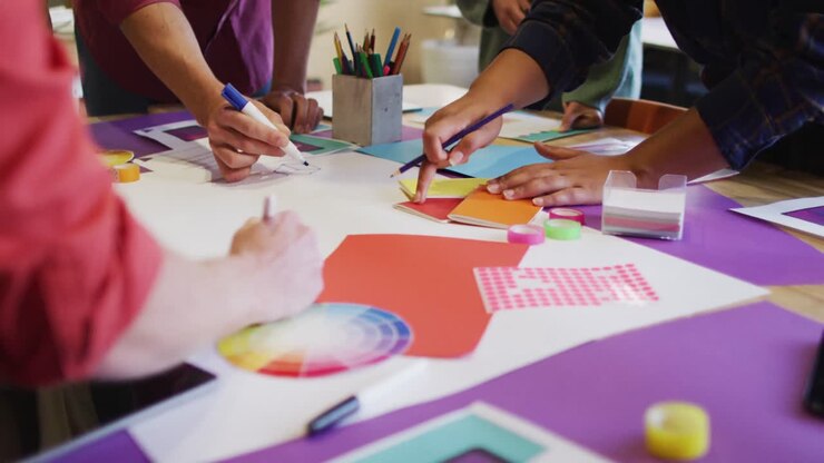 Diverse business people discussing work with schema during meeting at office