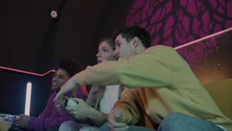 bottom view of three friends sitting on sofa at home