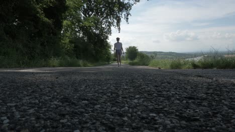 girl having a walk on a straight road in the hills