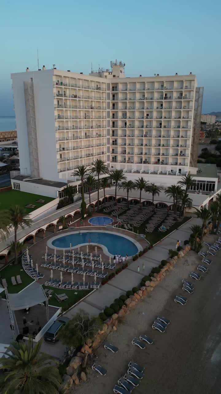 Drone footage captures cinematic, vertical shots of Doblemar Hotel in La Manga, starting from afar over the sea and zooming in to a closer focus.