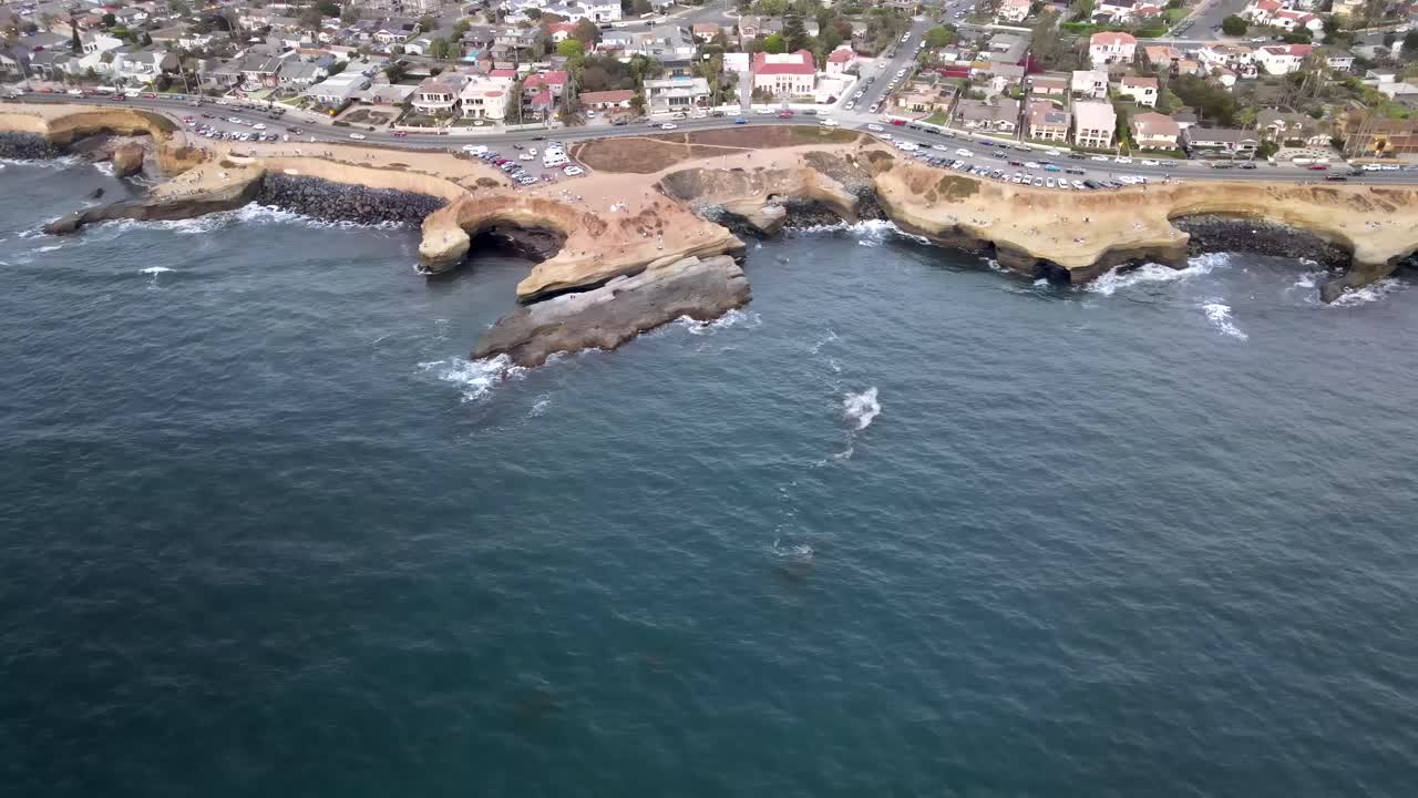 Aerial: California Pacific coast, houses overlooking Pacific Ocean on Sunset Cliffs