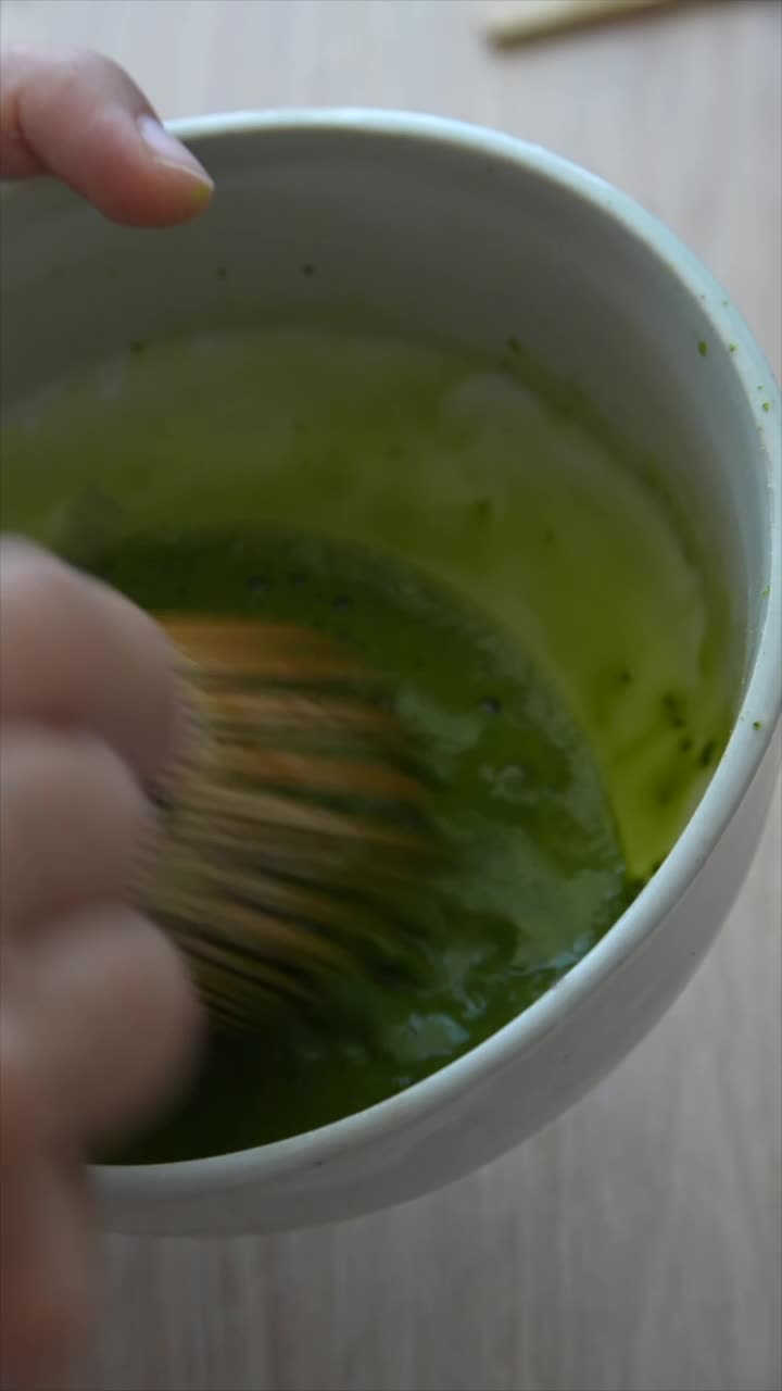 Preparing Matcha Tea with a Traditional Whisk