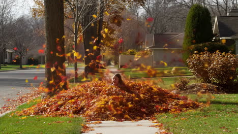 a girl jumping and playing in a pile of autumn leaves