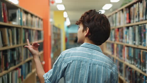 a person in a library surrounded by books