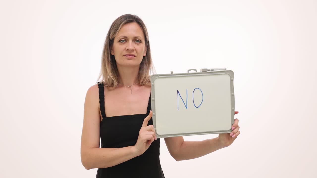 Woman holding a sign that says no