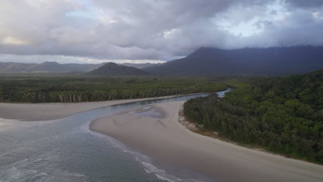 river meeting the ocean at daintree national park in far north queensland, australia - aerial drone shot