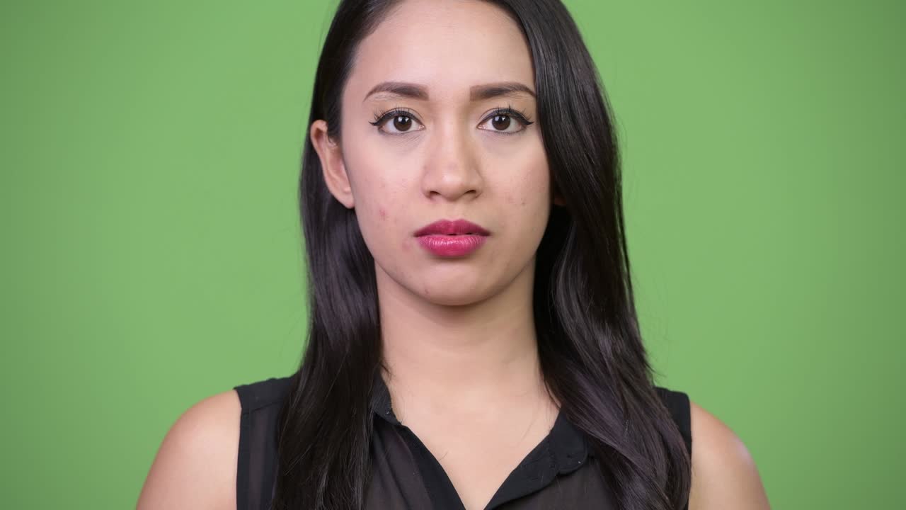 Young beautiful Asian businesswoman covering ears as three wise monkeys concept