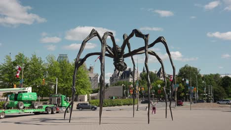 Sculpture ''Maman'' in front of the National Gallery of Canada with the Parliament of Canada in the background in Ottawa, Canada on a sunny summer day - 4K