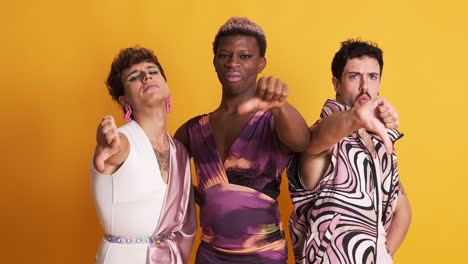 multiethnic transgender men gesturing disapproval with their thumbs down