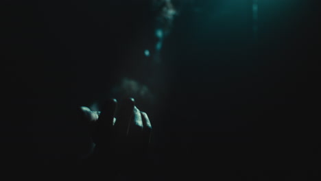 the witch makes a beckoning gesture with her hand
