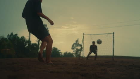 penalty kick blocked by goalie in slow motion, dramatic action scene on a dirt field
