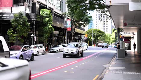 vehicles and pedestrians in a bustling city street