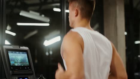 man running on treadmill in gym