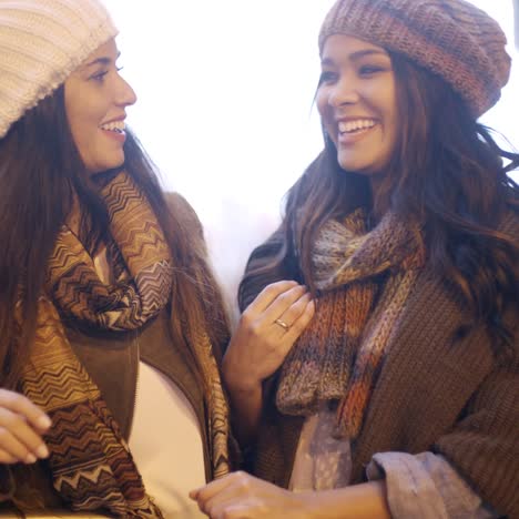 two stylish young women in winter fashion