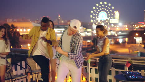friends having fun on rooftop party at night