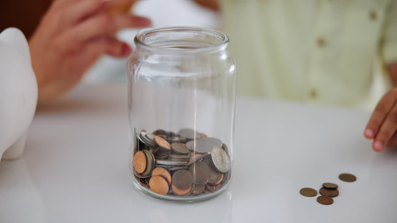 Child Saving Money in a Jar
