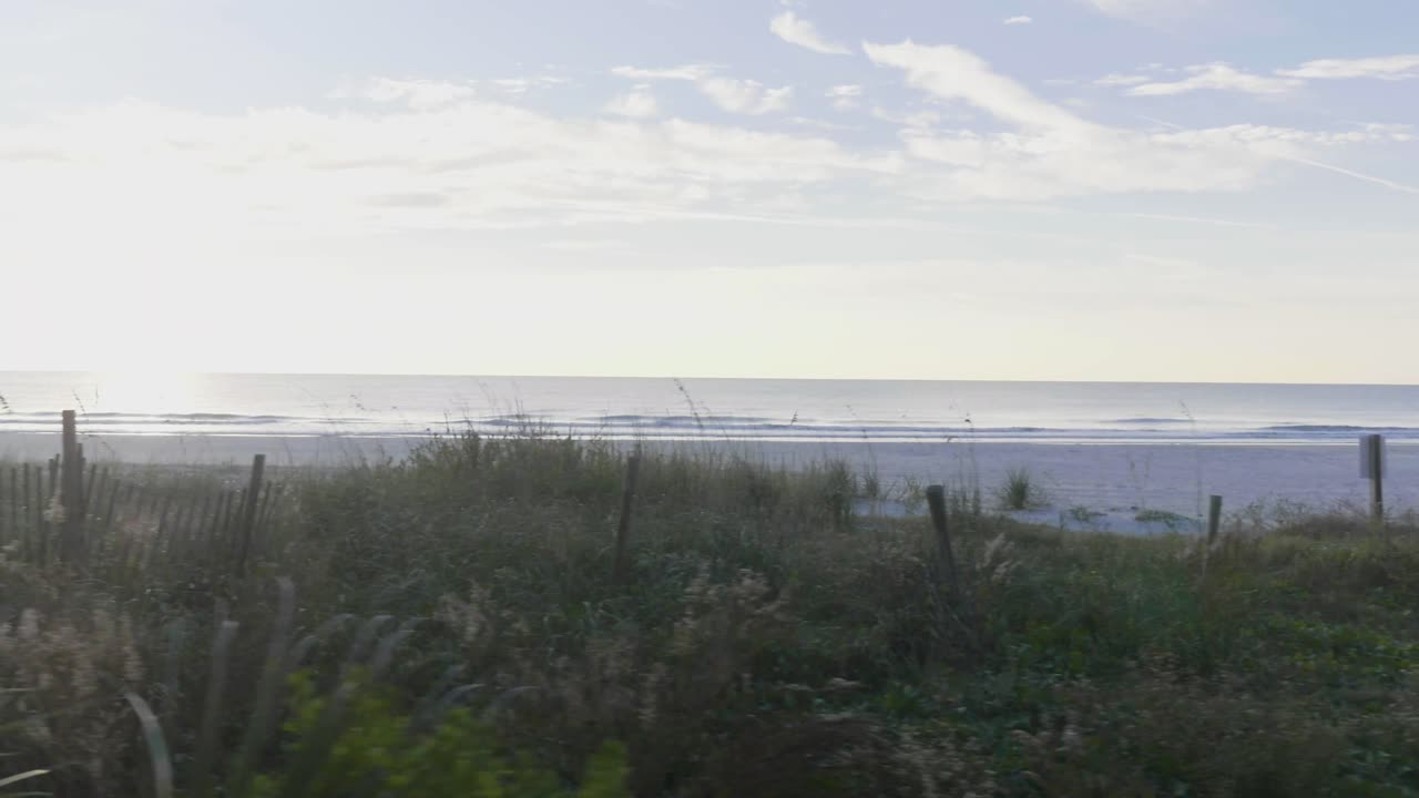 Walking across the boardwalk along side the beach.