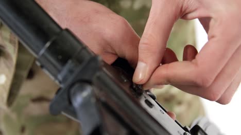 soldier adjusting rifle