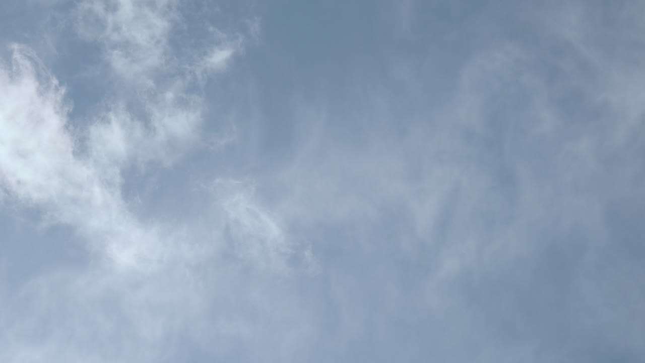 Clouds drifting across blue sky