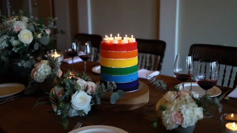 Rainbow Layer Cake with Candles on a Festive Table Setting