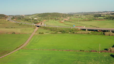 Aerial:-A-highway-going-through-the-country-side-of-the-Algarve-in-Portugal