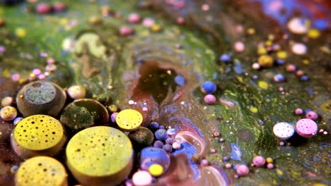 abstract colorful acrylic and food paint bubbles on water