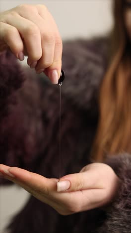 woman applying face oil