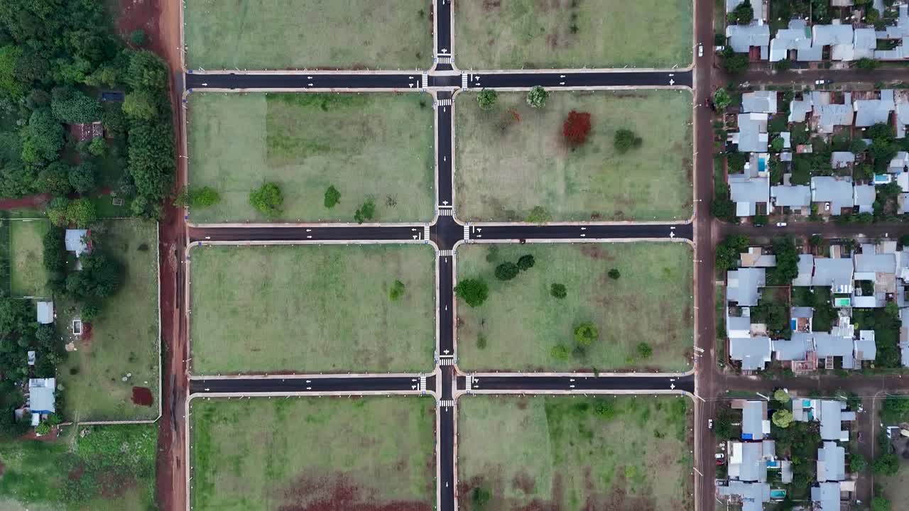 Top-down drone fly over the countryside housing lots ready for construction, Posadas, Misiones, Argentina