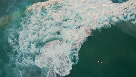 Una-Vista-Desde-Arriba-De-Los-Surfistas-En-El-Océano-En-Llandudno,-Ciudad-Del-Cabo,-Sudáfrica---Vista-Aérea-De-Arriba-Hacia-Abajo