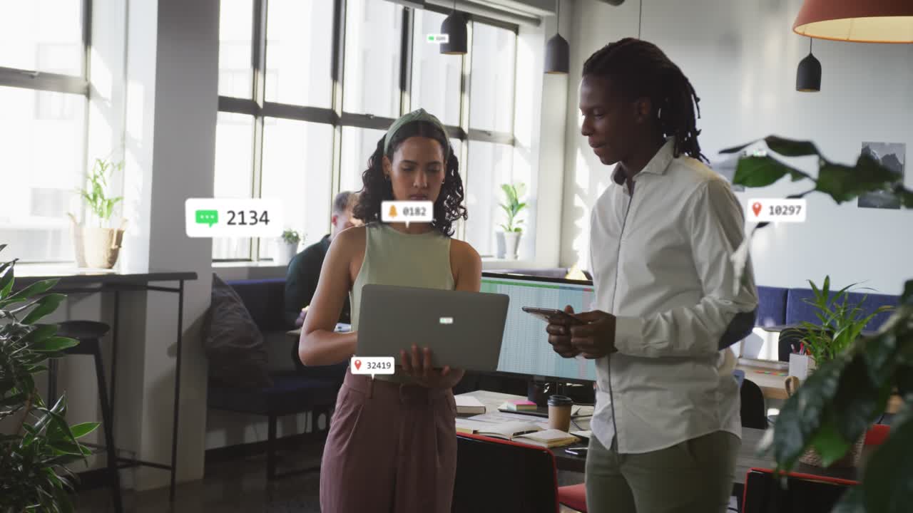 Animation of notification bars over diverse coworkers standing and discussing reports on laptop