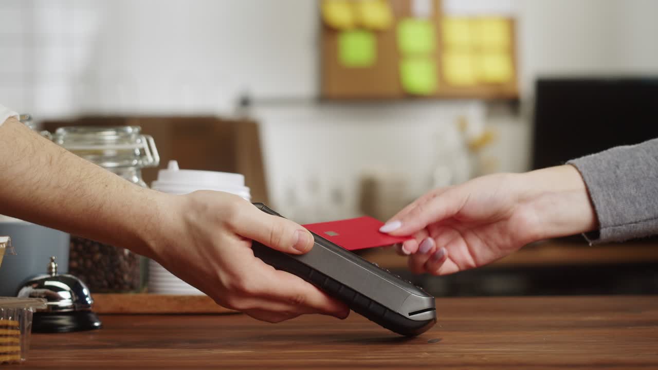 Paying with credit bank card in cafe. Touch-free and contactless food shopping in restaurant. NFC technology concept.