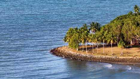 aerial view of a tropical island through an airplane window, transitioning smoothly from interior to full landscape view