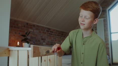 child painting wooden furniture