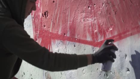 young man painting graffiti on wall. slow-motion