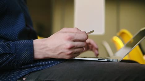 male hands typing something on laptop keyboard.