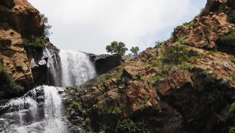 Crocodile-river-waterfall-flowing-and-falling-over-rocks-at-the-walter-sisulu-national-botanical-gardens-in-roodepoort,-South-Africa