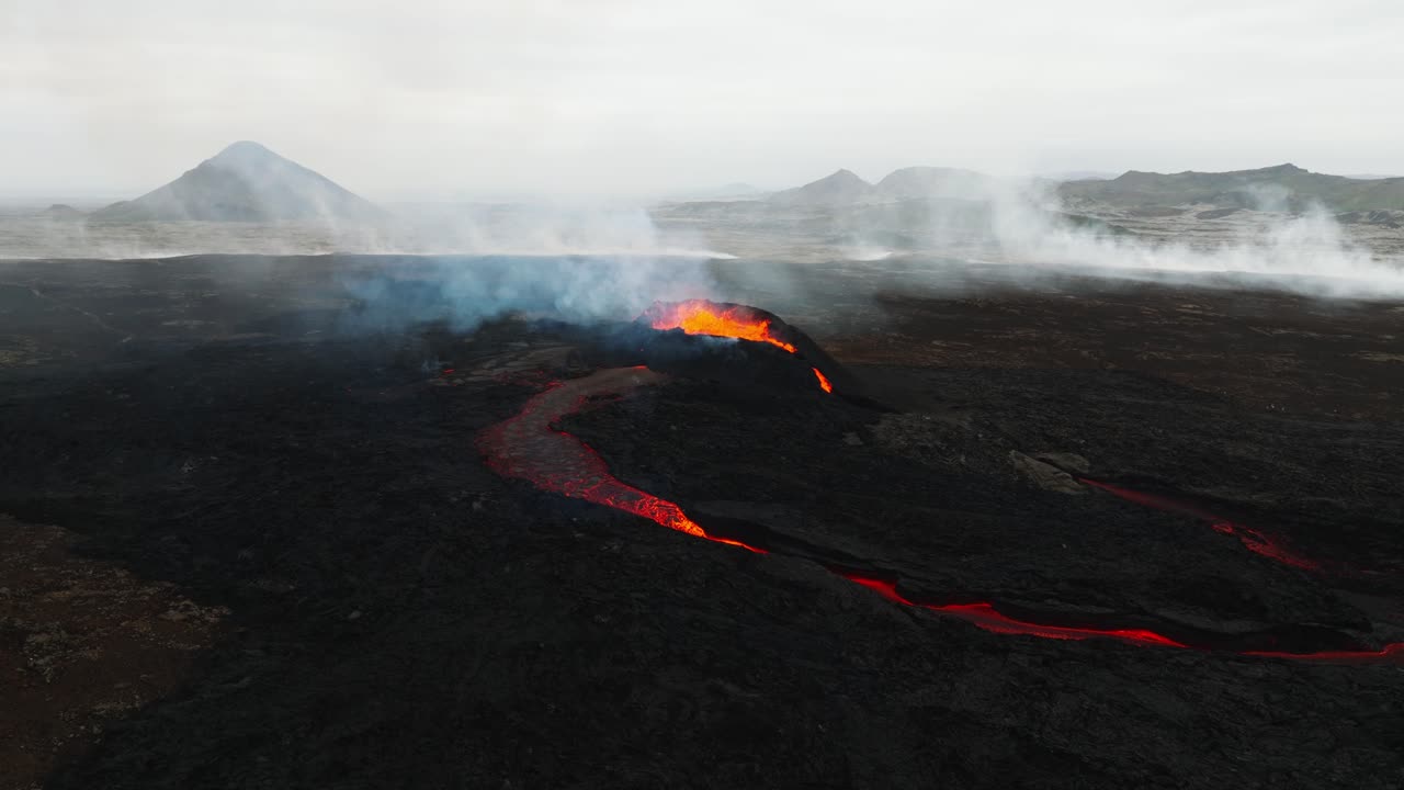 Aerial landscape view of the volcano erupting at Litli-Hrutur, Iceland, with lava and smoke coming up