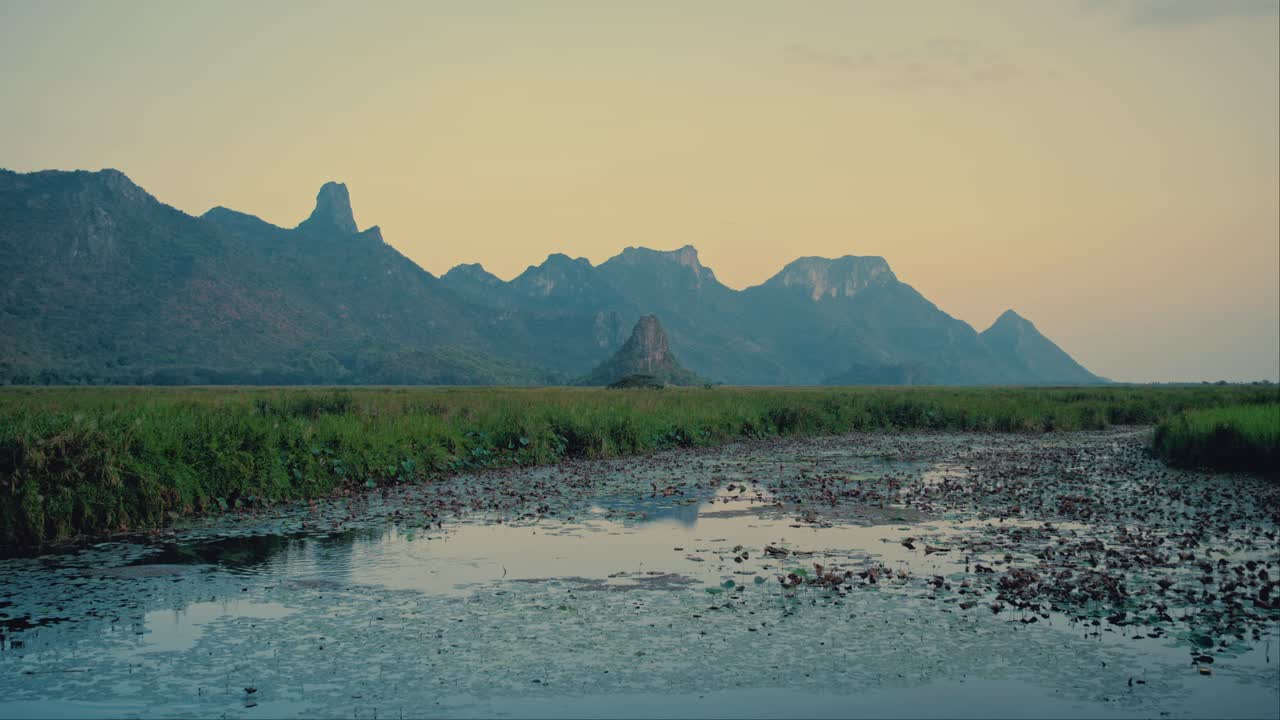 Limestone hills and calm marsh at sunset in Khao Sam Roi Yot national park in Thailand