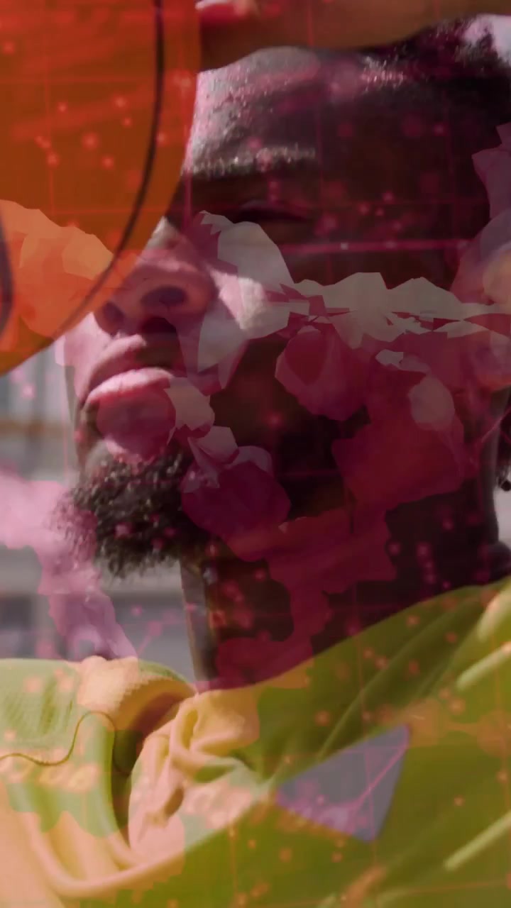 Vertical video: Cam pulling back nudging man raising ball overhead for sports shot with floral veil