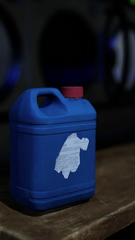 blue laundry detergent bottle in laundry room