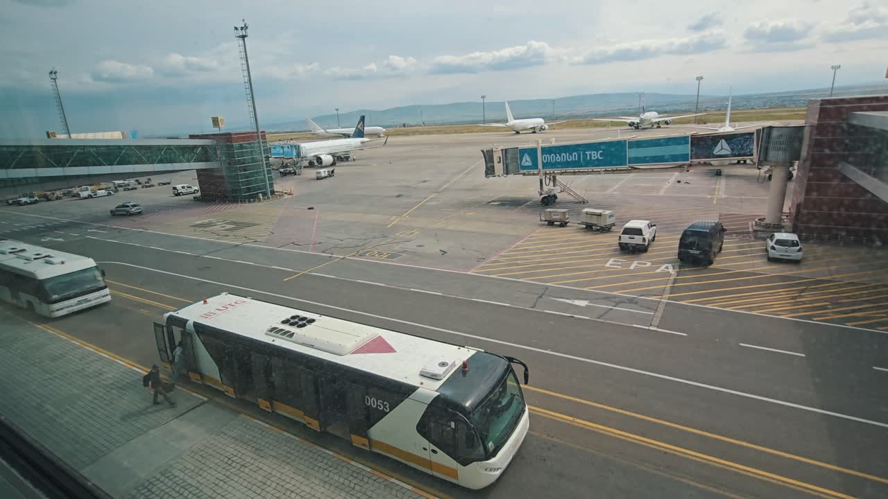 Airport Tarmac with Airplanes and Shuttle Bus