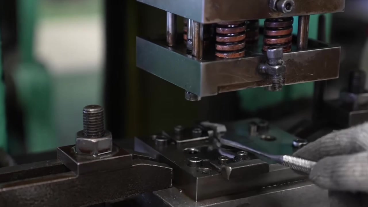 Close-up of mechanical stamping press die with springs forming pliers components